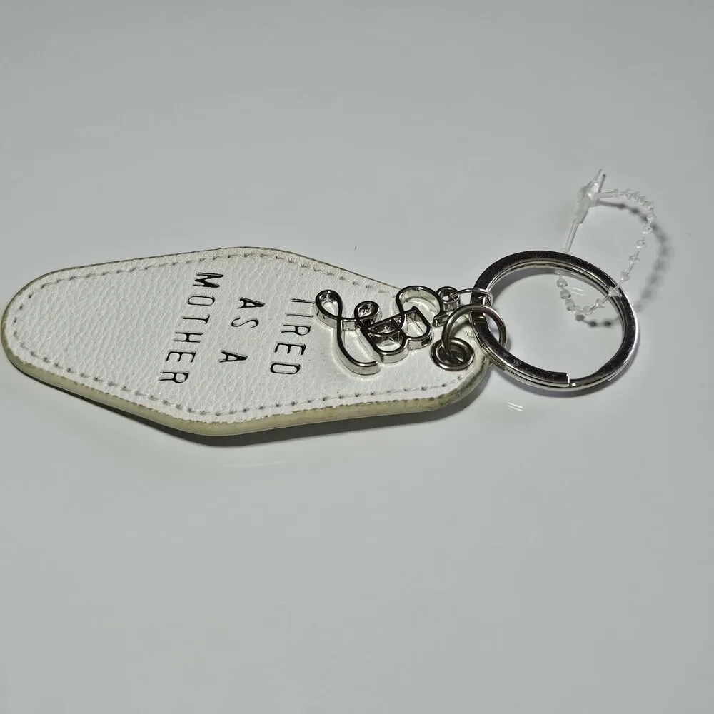Santa Barbara Design Studio Silver Tone White Leather Tired As A Mother Keychain